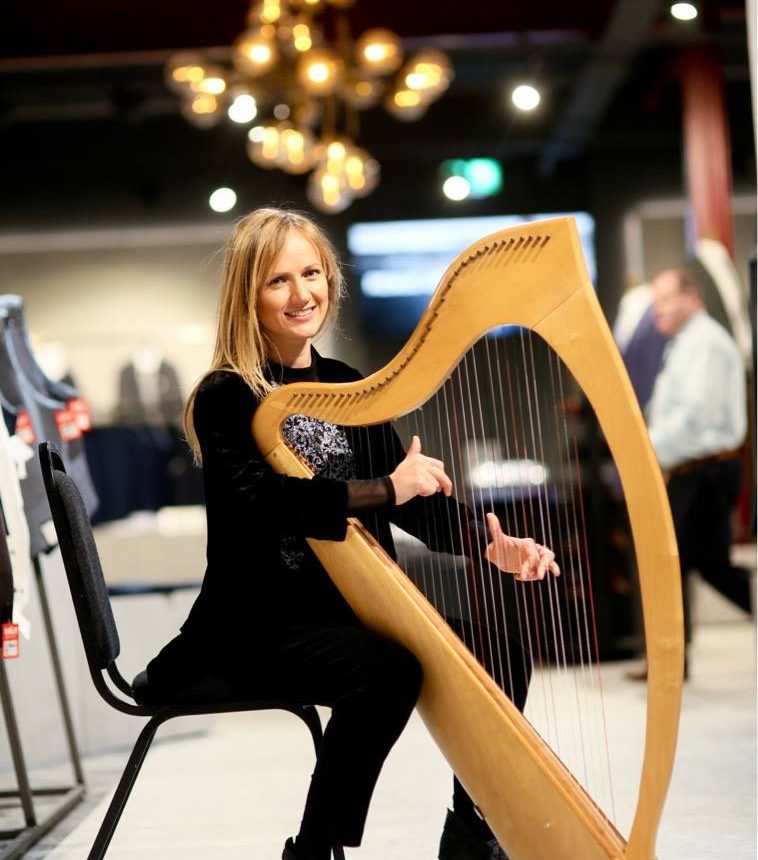 Amy McAllister playing harp and singing for culture night, Ballymena